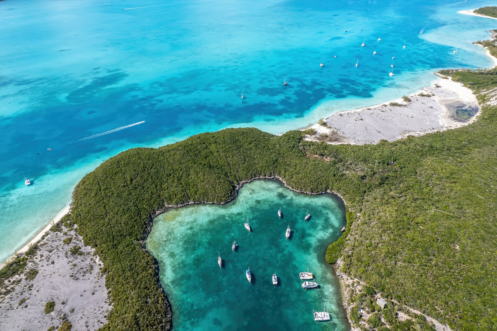 Aerial view of anchored sailing yacht in emerald Caribbean sea, Stocking Island, Great Exuma, Bahamas.